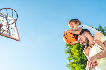 Father and son playing basketball