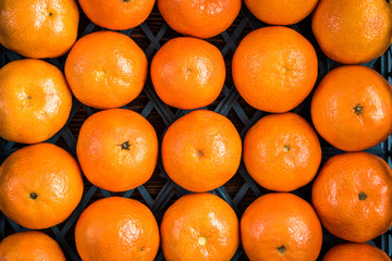 Mandarines on wooden background.