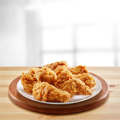 crispy coated batter southern style fried chicken in a wooden table