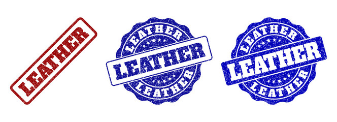 LEATHER grunge stamp seals in red and blue colors. Vector LEATHER watermarks with grunge surface. Graphic elements are rounded rectangles, rosettes, circles and text captions.