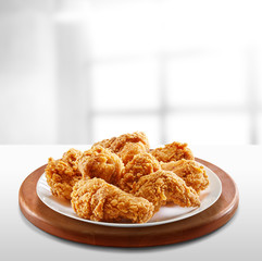 crispy coated batter southern style fried chicken in a wooden table
