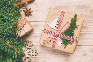 Christmas vintage, toned background with fir tree and gift box on wooden table. Top view with copy space for your design