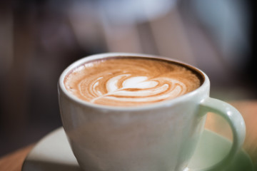 Coffee latte hearts shaped stacked on wooden floor
