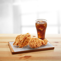 crispy coated batter southern style fried chicken in a wooden table