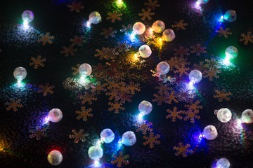 Fototapeta na wymiar Small shining colorful christmas bulbs.
