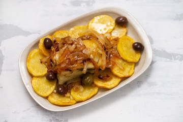 baked cod fish with potato, onion and olives