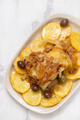 baked cod fish with potato, onion and olives