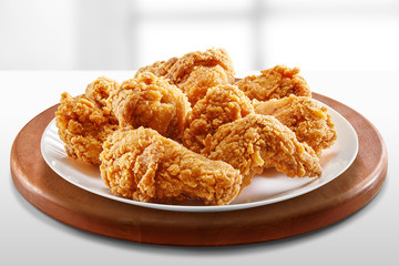 crispy coated batter southern style fried chicken in a wooden table