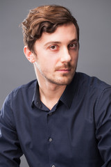 Studio portrait of young man on a dark background