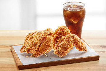 crispy coated batter southern style fried chicken in a wooden table