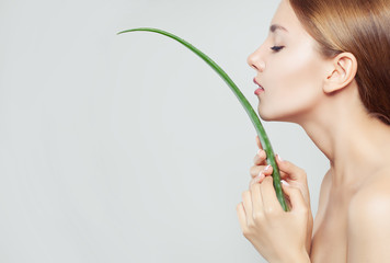Healthy woman with clear skin and aloe leaf