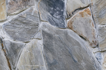 the texture of gray stone masonry wall