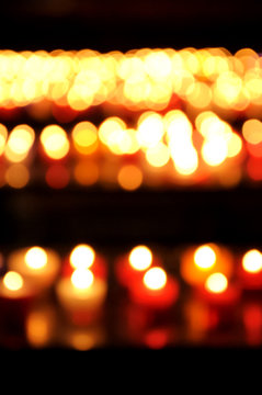Blurred photo of candles in church. Bokeh.