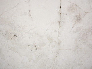 Old concrete wall texture with cracked, peeling white paint