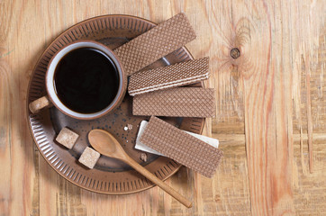 Chocolate wafers and coffee in a plate