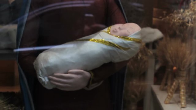  Mary with baby Jesus,showcase of baby's store and Jesus on her hands in Mary