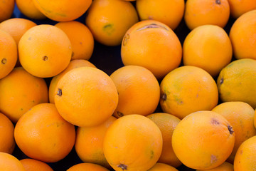 yellow and fresh lemon tropic fruits on market counter background texture