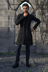 3d render of a fantasy nobleman standing against stone arch among ancient ruins