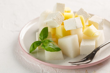 fruit salad with cheese. Mango, melon with cheese and Basil
