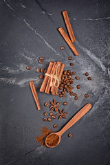 Top view of ingredients for spicy beverage - coffee beans, cinnamon sticks and anise stars