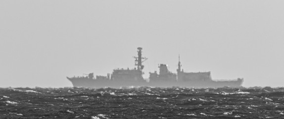 STORMY SEA - Outline of a warship on the horizon
