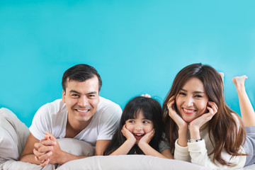 Fototapeta premium Portrait happy Asian family over blue background