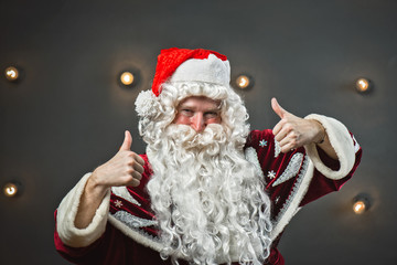 Portrait of a steep Santa Claus on a gray background