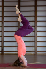 Sporty young woman doing yoga practice - concept of healthy life and natural balance between body...