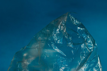 Abstract Background Textures. Cropped Shot Of Plastic Bag Over Blue Background.  Environmental Problems And Nature Pollution Concept. 
