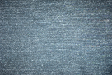 Old blue denim jeans texture or background with visible fibers