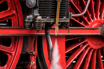 Detail of a steam locomotive with white Steam, white Steam, Detail of Big red Wheels, rod Drive