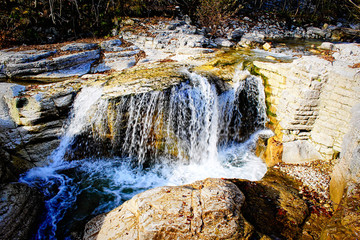 beautiful waterfall in forest, autumn landscape.