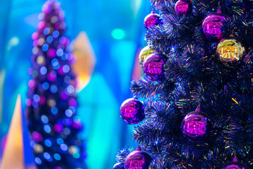 Soft focus decorative disco ball close-up. Decorated Christmas tree on blurred, sparkling fairy...