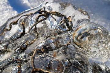 ice covered wire mesh on lakeshore breakwater, Finland