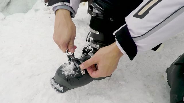 Skier putting his ski. man ready for skiing