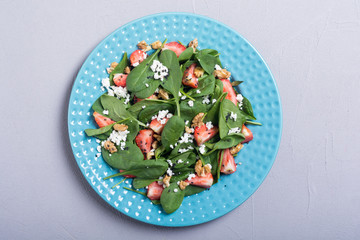 Strawberry salad with spinach , cheese and walnut . Healthy food
