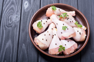 Raw chicken legs with spices and parsley. Food background