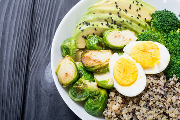 Buddha bowl with quinoa , eggs , avocado , brussels sprouts and broccoli