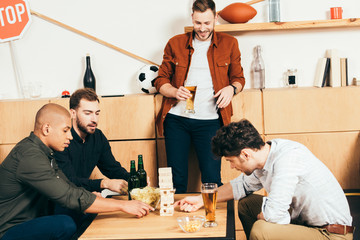 multiethnic friends playing blocks wood game in cafe
