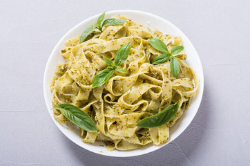 Pasta tagliatelle with green sauce pesto . Italian food background