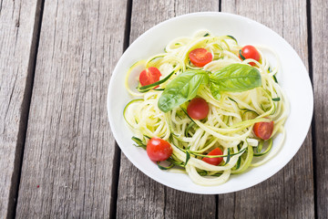 Zucchini pasta noodles with tomatoes . Healthy vegetarian food