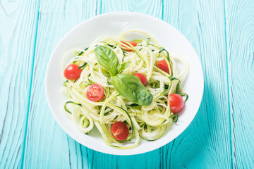 Zucchini pasta noodles with tomatoes . Healthy vegetarian food