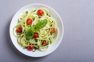 Zucchini pasta noodles with tomatoes . Healthy vegetarian food