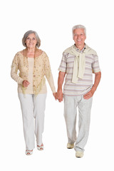 Portrait of senior couple holding hands on white background