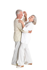 Portrait of senior couple dancing on white background