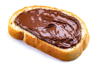 Isolated piece of loaf with spread chocolate paste on a white background. Sweet, nut butter with fresh bread for breakfast.
