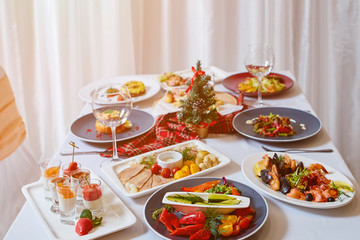 Christmas Dinner. A table in the restaurant, served for two people, is ready for the New Year