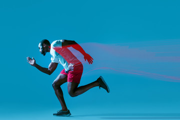 Fototapeta na wymiar Full length portrait of active young muscular running man,