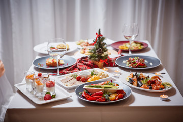 Beautifully served table with food. Festive atmosphere and decor. Celebration together