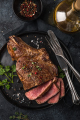 sliced beef steak on black plate